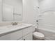 Well-lit bathroom with a modern sink, mirror, and a shower-tub combination at 54 Reed Ne St, Concord, NC 28025