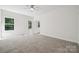 Bright bedroom featuring neutral carpet, a ceiling fan, and natural light from the windows at 54 Reed Ne St, Concord, NC 28025