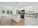 Modern kitchen with white cabinetry, stainless steel appliances, and granite countertops at 54 Reed Ne St, Concord, NC 28025