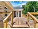 Spacious wooden back deck featuring cable railing, access to a screened porch, and lawn views at 6249 Hayden Dr, Hickory, NC 28601