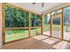 The home's screened-in back porch has wood floors and views of a lush backyard at 6249 Hayden Dr, Hickory, NC 28601