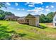 Exterior shot of a new construction brick home with a wood deck and porch overlooking a lush yard at 6249 Hayden Dr, Hickory, NC 28601