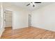 Spacious bedroom featuring hardwood floors, a ceiling fan, and a walk-in closet at 6249 Hayden Dr, Hickory, NC 28601