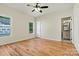 Bedroom featuring wood floors, a ceiling fan, and a view into the connected bathroom at 6249 Hayden Dr, Hickory, NC 28601