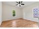 Bright bedroom features hardwood floors, ceiling fan, and natural light from two windows at 6249 Hayden Dr, Hickory, NC 28601