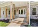 Inviting front porch featuring sturdy wooden columns, a glass front door, and manicured landscaping, offering curb appeal at 6249 Hayden Dr, Hickory, NC 28601