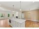 Gourmet kitchen showcasing modern island with stainless steel microwave and hardwood floors at 6249 Hayden Dr, Hickory, NC 28601