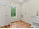 Bright laundry room with wood flooring, white cabinetry, sink, and a window with a scenic view at 6249 Hayden Dr, Hickory, NC 28601