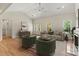 Bright living room featuring a ceiling fan, wood floors, natural light, and comfortable seating at 6249 Hayden Dr, Hickory, NC 28601
