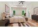Bright main bedroom featuring hardwood floors, ceiling fan, and an ensuite bathroom at 6249 Hayden Dr, Hickory, NC 28601
