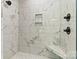 Modern shower featuring marble tiling, a built-in bench and modern fixtures at 6249 Hayden Dr, Hickory, NC 28601