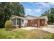 Exterior backyard featuring patio, brick and vinyl siding, and screened porch at 6300 Morehead Rd, Harrisburg, NC 28075