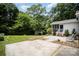 Backyard with a patio, mature trees, and storage shed at 6300 Morehead Rd, Harrisburg, NC 28075