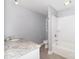 Bathroom with white subway tile, granite countertop, and tub with shower at 6300 Morehead Rd, Harrisburg, NC 28075