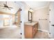 Well-appointed bathroom with wood vanity, granite countertop, and access to bedroom at 6300 Morehead Rd, Harrisburg, NC 28075
