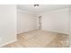 Cozy bedroom with neutral carpet, crown molding, and a door to an ensuite bath at 6300 Morehead Rd, Harrisburg, NC 28075