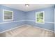 Bright bedroom with two large windows and neutral carpet at 6300 Morehead Rd, Harrisburg, NC 28075