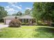 Charming brick home featuring a well-maintained lawn and welcoming front porch at 6300 Morehead Rd, Harrisburg, NC 28075