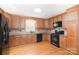 Updated kitchen featuring wood cabinets, modern appliances, and hardwood floors at 6300 Morehead Rd, Harrisburg, NC 28075