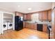 Well-equipped kitchen featuring granite countertops, wood cabinets, and modern appliances at 6300 Morehead Rd, Harrisburg, NC 28075