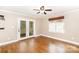 Bright room with wood flooring, natural light, and access to outdoor screened porch at 6300 Morehead Rd, Harrisburg, NC 28075