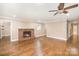 Cozy living room featuring hardwood floors, brick fireplace, and ample lighting at 6300 Morehead Rd, Harrisburg, NC 28075