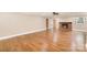 Spacious living room with hardwood floors, fireplace, and natural light at 6300 Morehead Rd, Harrisburg, NC 28075