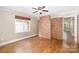 Comfortable living room with beautiful wood floors and a striking brick accent wall at 6300 Morehead Rd, Harrisburg, NC 28075