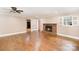 Bright living room with hardwood floors, fireplace, and ceiling fan at 6300 Morehead Rd, Harrisburg, NC 28075