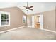 Spacious main bedroom featuring vaulted ceiling, windows, and a private ensuite bath at 6300 Morehead Rd, Harrisburg, NC 28075
