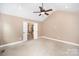 Large main bedroom with vaulted ceiling and ensuite bath access, featuring a ceiling fan at 6300 Morehead Rd, Harrisburg, NC 28075