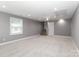 Finished basement offers a flexible living space with plush carpeting and a staircase at 6310 Forney Hill Rd, Denver, NC 28037