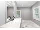 Bathroom featuring modern vanity, ample natural light, and stylish marble-look tile floors at 6310 Forney Hill Rd, Denver, NC 28037