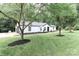 Beautiful house exterior with green lush lawn and trees, complemented by elegant landscaping around the foundation at 6310 Forney Hill Rd, Denver, NC 28037