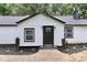 Charming house with black door, white siding and manicured front garden and sidewalk to the door at 6310 Forney Hill Rd, Denver, NC 28037