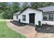 Charming home featuring white siding, a black front door, and beautifully landscaped front yard at 6310 Forney Hill Rd, Denver, NC 28037