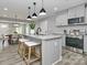Modern kitchen featuring granite countertops, stainless steel appliances, and stylish pendant lighting at 6310 Forney Hill Rd, Denver, NC 28037