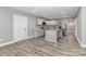 Open kitchen with stainless steel appliances, gray cabinets, granite countertops and large kitchen island at 6310 Forney Hill Rd, Denver, NC 28037