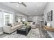 Spacious living room with a large sectional sofa, decorative rug, and plenty of natural light at 6310 Forney Hill Rd, Denver, NC 28037