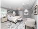 Relaxing primary bedroom with a neutral palette, ceiling fan, ensuite bathroom, and a comfortable seating area at 6310 Forney Hill Rd, Denver, NC 28037