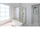 Clean, modern bathroom showcases a glass-enclosed shower and a separate bathtub for relaxation and convenience at 6507 Fairway Point Dr, Charlotte, NC 28269