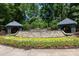 Stone Highland Creek community entrance with colorful flower beds and dual stone covered entrance features at 6507 Fairway Point Dr, Charlotte, NC 28269