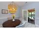 Cozy dining area highlighted by an elegant light fixture, a round table, and patio access at 6507 Fairway Point Dr, Charlotte, NC 28269