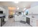 Bright, open kitchen with white cabinets, stainless steel appliances, and modern countertops flows into dining and living areas at 6507 Fairway Point Dr, Charlotte, NC 28269