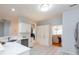Bright kitchen with white cabinets, quartz countertops, stainless steel appliances and an open-concept design at 6507 Fairway Point Dr, Charlotte, NC 28269