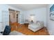 Cozy living room area with hardwood floors and French doors with a cozy chaise lounge at 6507 Fairway Point Dr, Charlotte, NC 28269