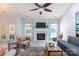 Cozy living room featuring a marble fireplace, French doors, and comfortable seating for relaxation and entertainment at 6507 Fairway Point Dr, Charlotte, NC 28269