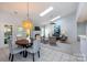 Open living and dining area with vaulted ceilings, skylights, fireplace, and stylish furnishings provides a cozy atmosphere at 6507 Fairway Point Dr, Charlotte, NC 28269