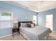 Well-lit main bedroom offers a cozy and inviting space with a neutral color palette and comfortable furnishings at 6507 Fairway Point Dr, Charlotte, NC 28269