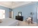 Calming main bedroom showcases a tray ceiling, light blue walls, neutral carpet, and a charming accent chair at 6507 Fairway Point Dr, Charlotte, NC 28269